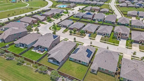 an aerial view of residential houses with outdoor space