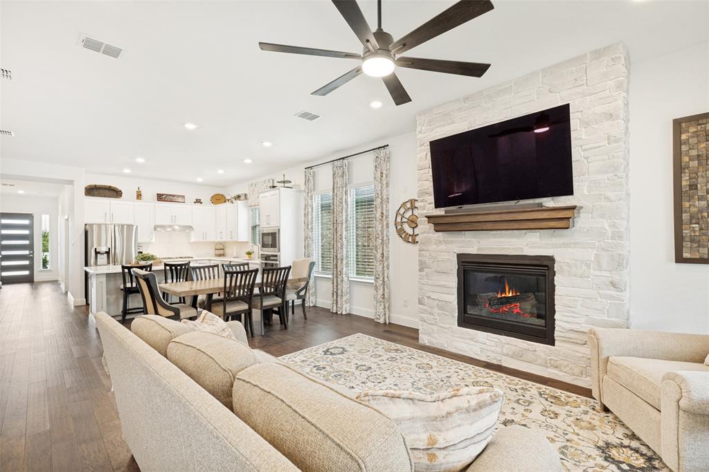 229 Savannah Lane Oak Point, TX 75068 - Photo 9 of 26 a living room with furniture a flat screen tv and a fireplace