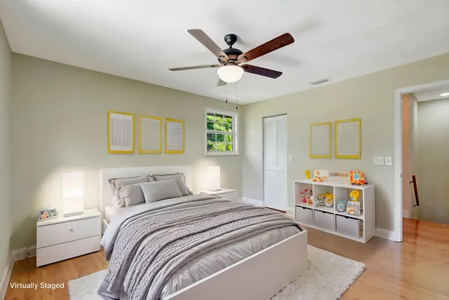 an empty room with windows and ceiling fan