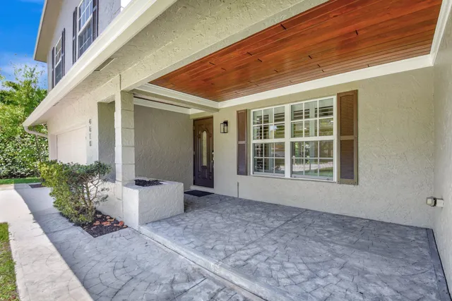 a view of a backyard with plants and entertaining space