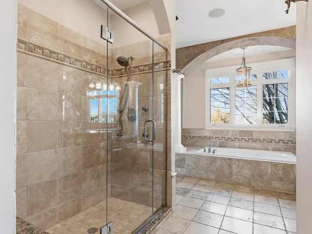 a bathroom with a granite countertop sink a toilet and shower
