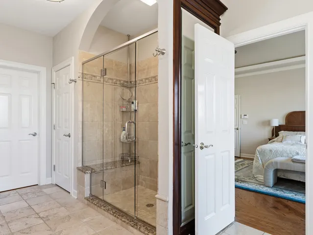 a bedroom with a bed and a chandelier