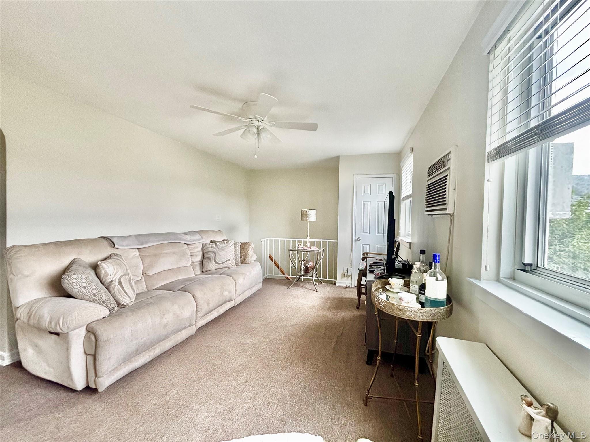 72-29 Little Neck Parkway, Unit 2 Queens, NY 11426 - Photo 14 of 24 a living room with furniture and a large window