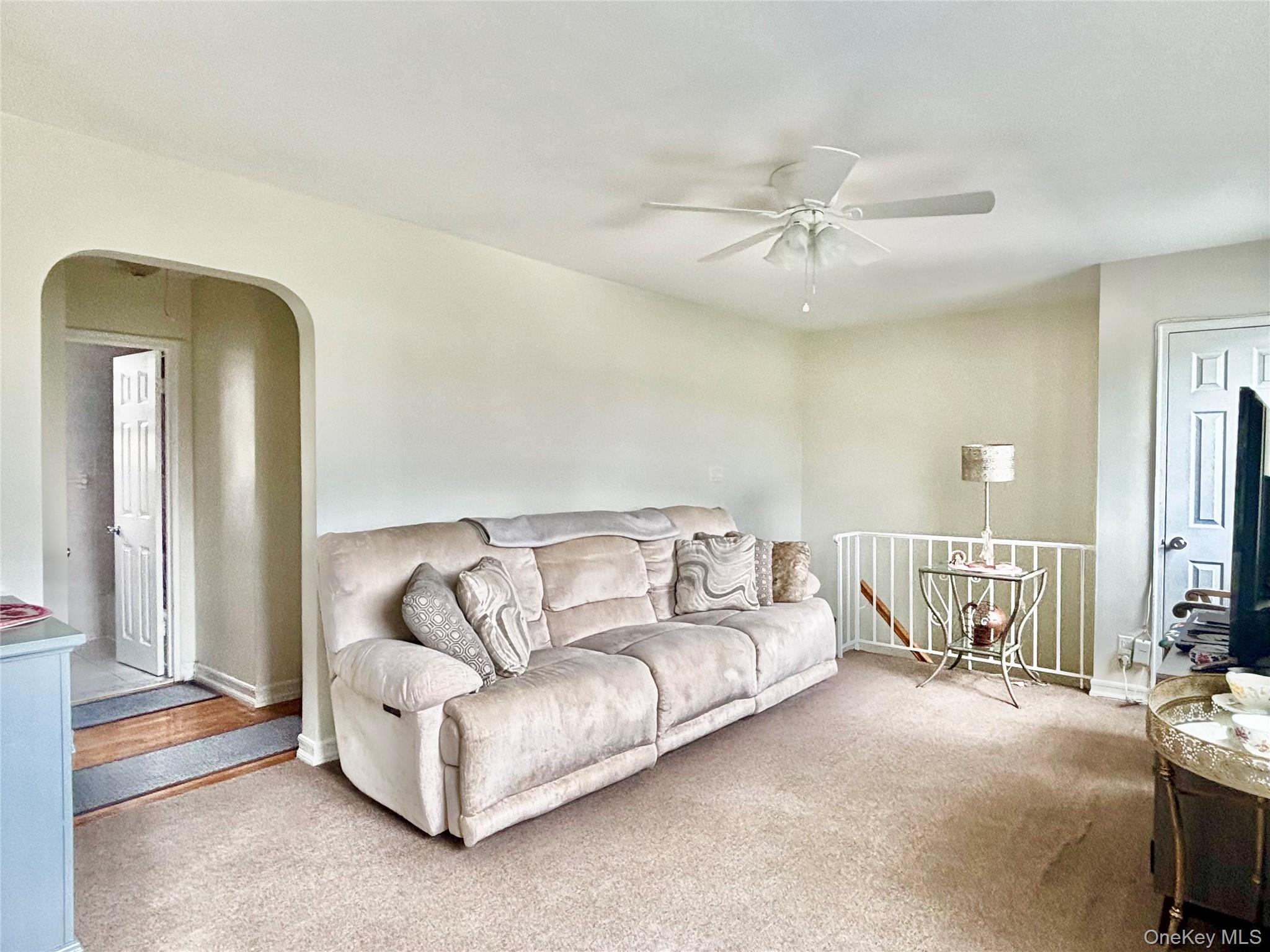 72-29 Little Neck Parkway, Unit 2 Queens, NY 11426 - Photo 15 of 24 a living room with furniture and a chandelier