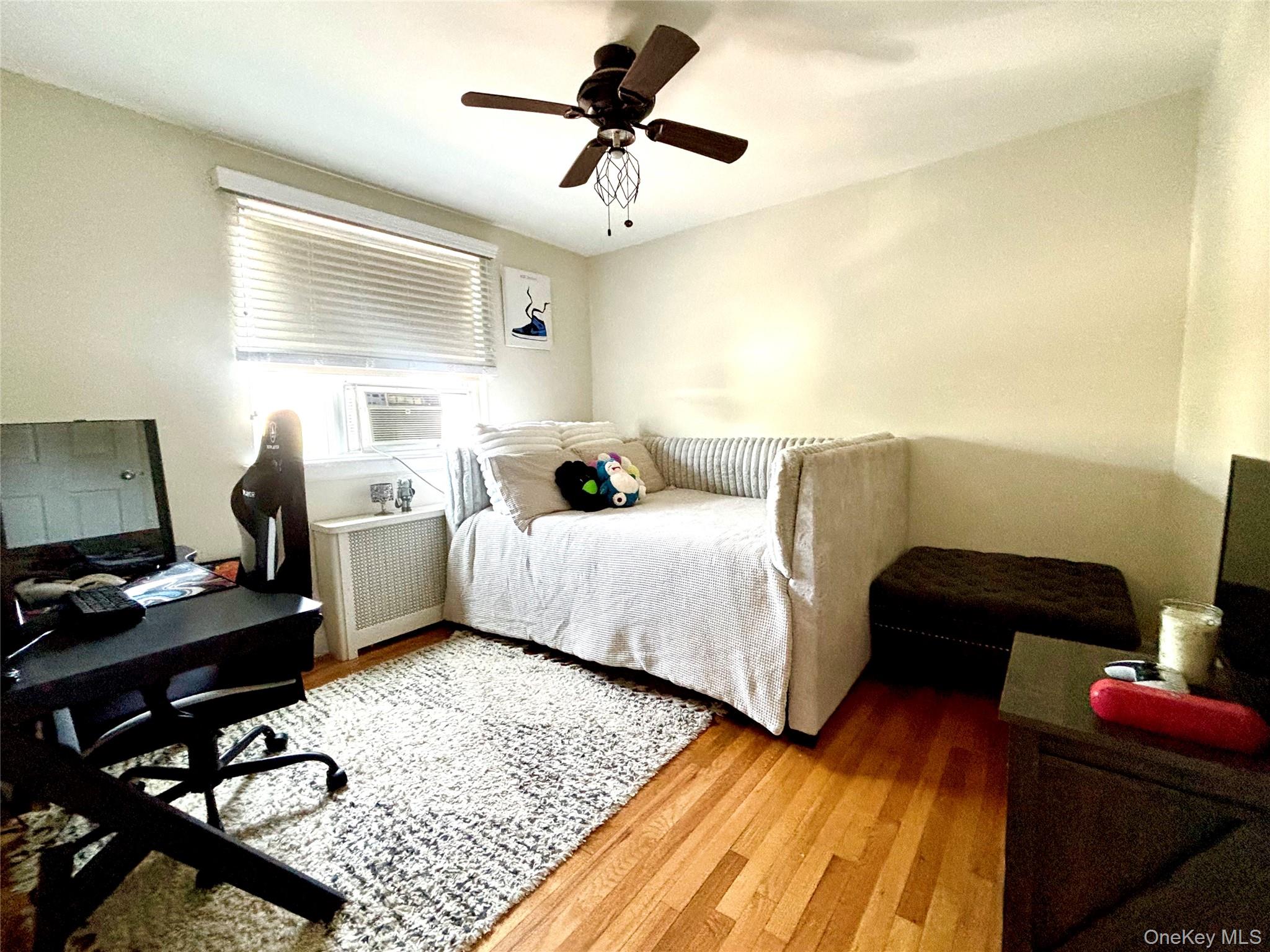 72-29 Little Neck Parkway, Unit 2 Queens, NY 11426 - Photo 19 of 24 a bedroom with a bed and wooden floor