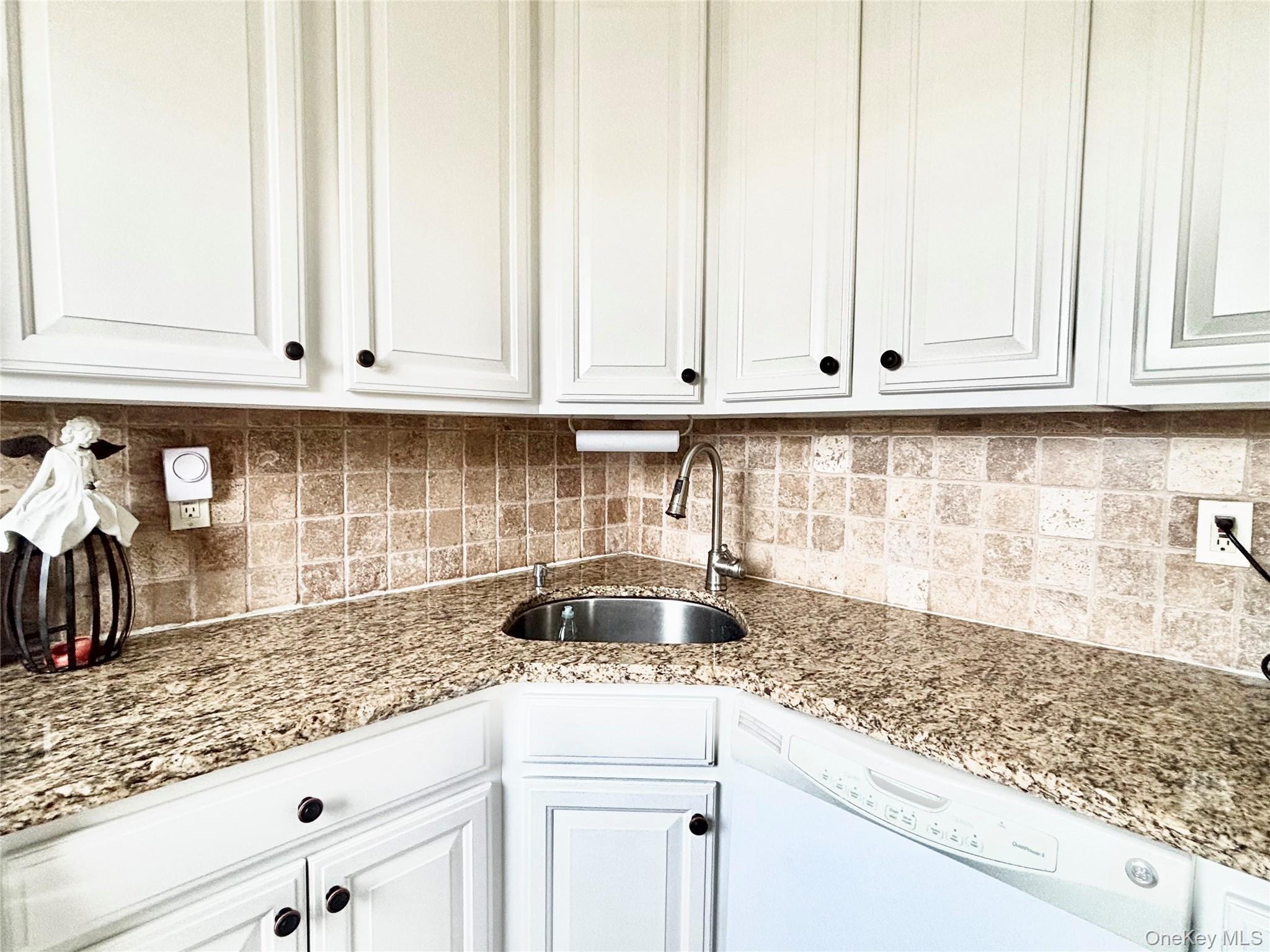 72-29 Little Neck Parkway, Unit 2 Queens, NY 11426 - Photo 6 of 24 a kitchen with granite countertop white cabinets and a sink