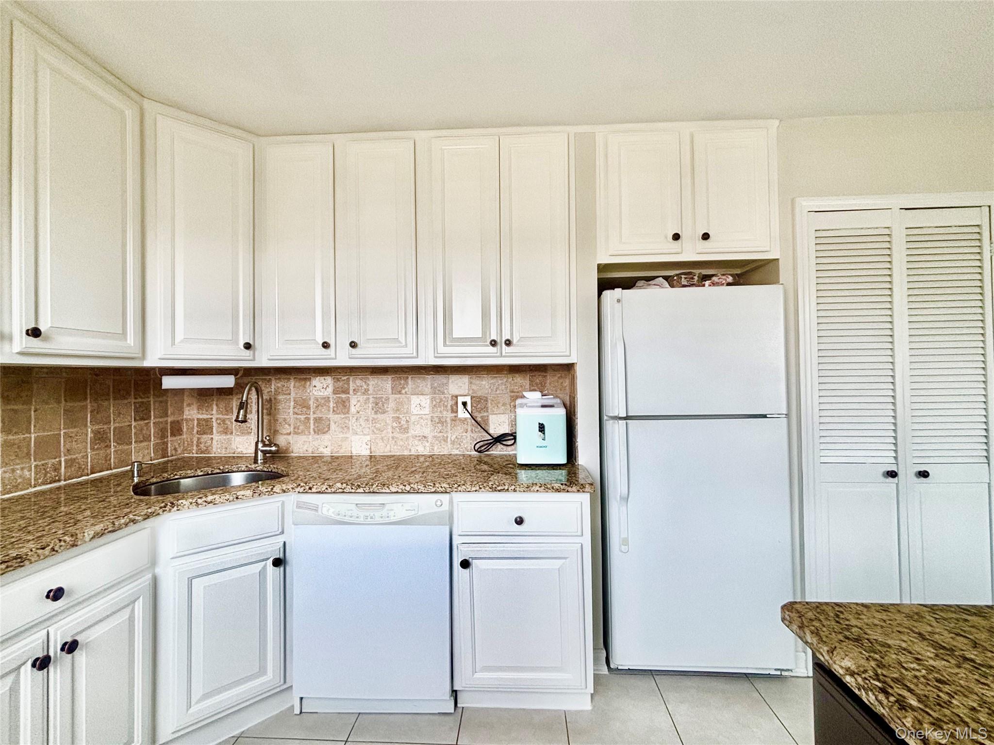 72-29 Little Neck Parkway, Unit 2 Queens, NY 11426 - Photo 7 of 24 a kitchen with appliances a sink and cabinets