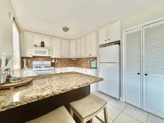 a kitchen with refrigerator and window