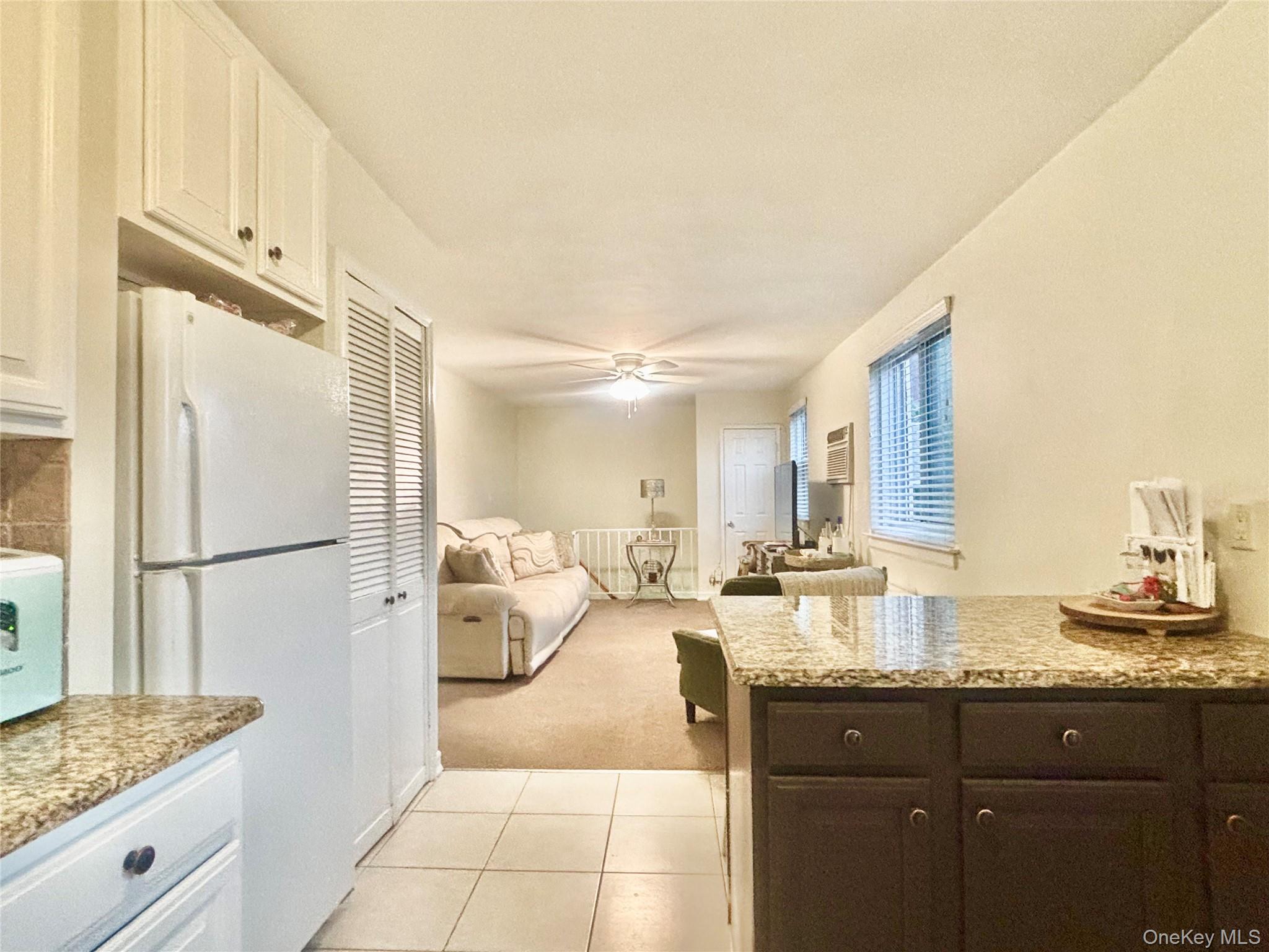 72-29 Little Neck Parkway, Unit 2 Queens, NY 11426 - Photo 10 of 24 a large bathroom with a granite countertop sink and a mirror
