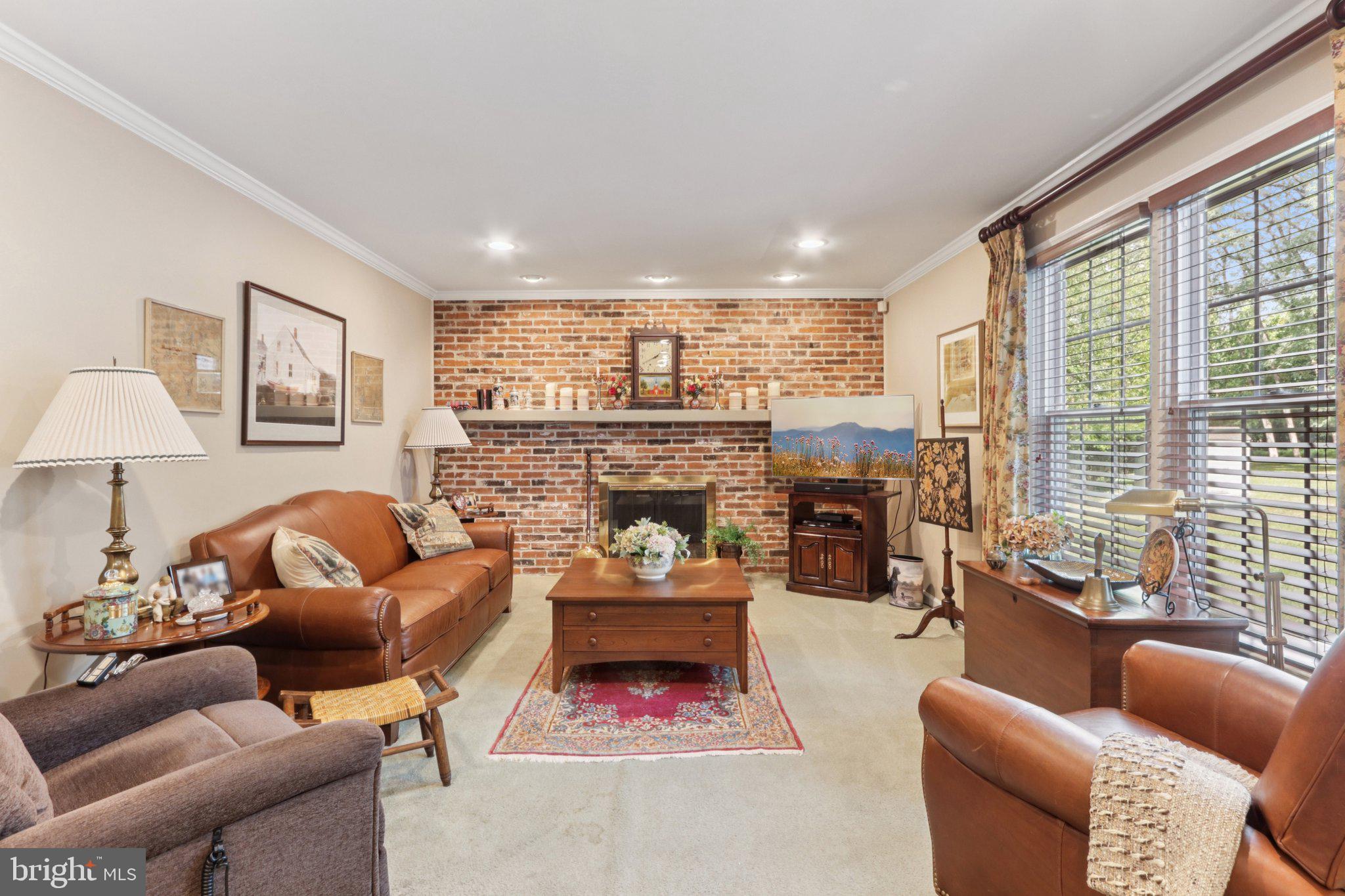 294 Batleson Road Ambler, PA 19002 - Photo 12 of 50 a living room with furniture a fireplace and a large window