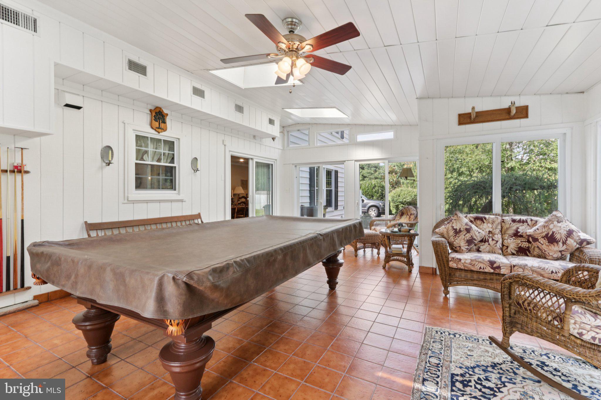 294 Batleson Road Ambler, PA 19002 - Photo 23 of 50 a dining hall with couches a dining table and chairs with a large window