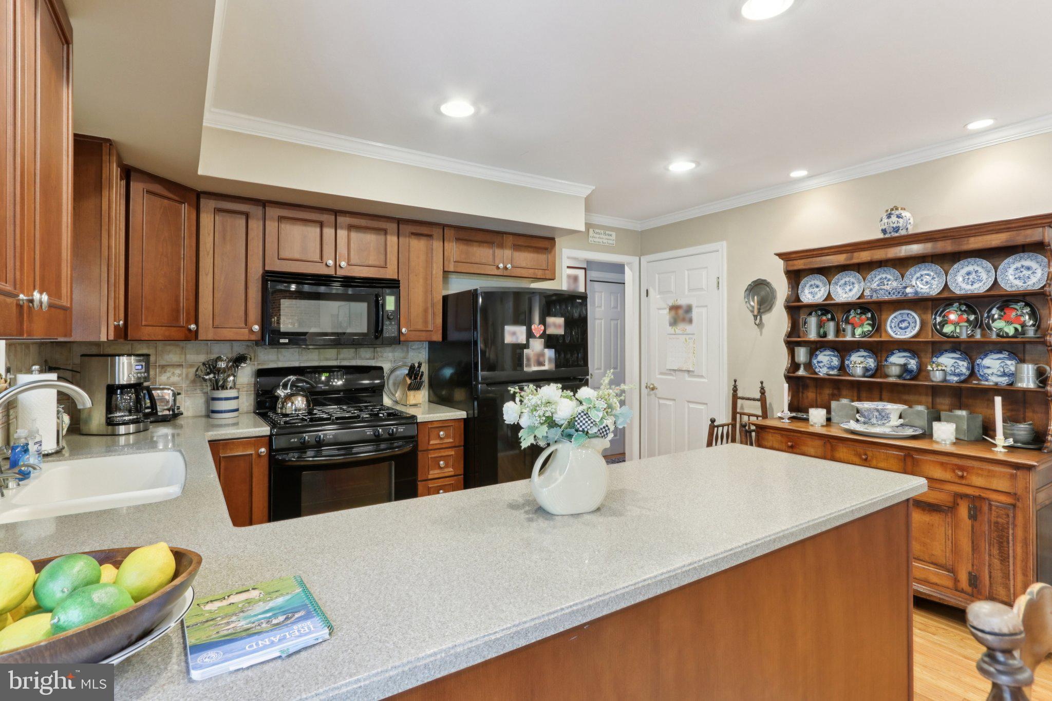 294 Batleson Road Ambler, PA 19002 - Photo 8 of 50 a kitchen with stainless steel appliances granite countertop a refrigerator a stove top oven a sink dishwasher and white cabinets with wooden floor
