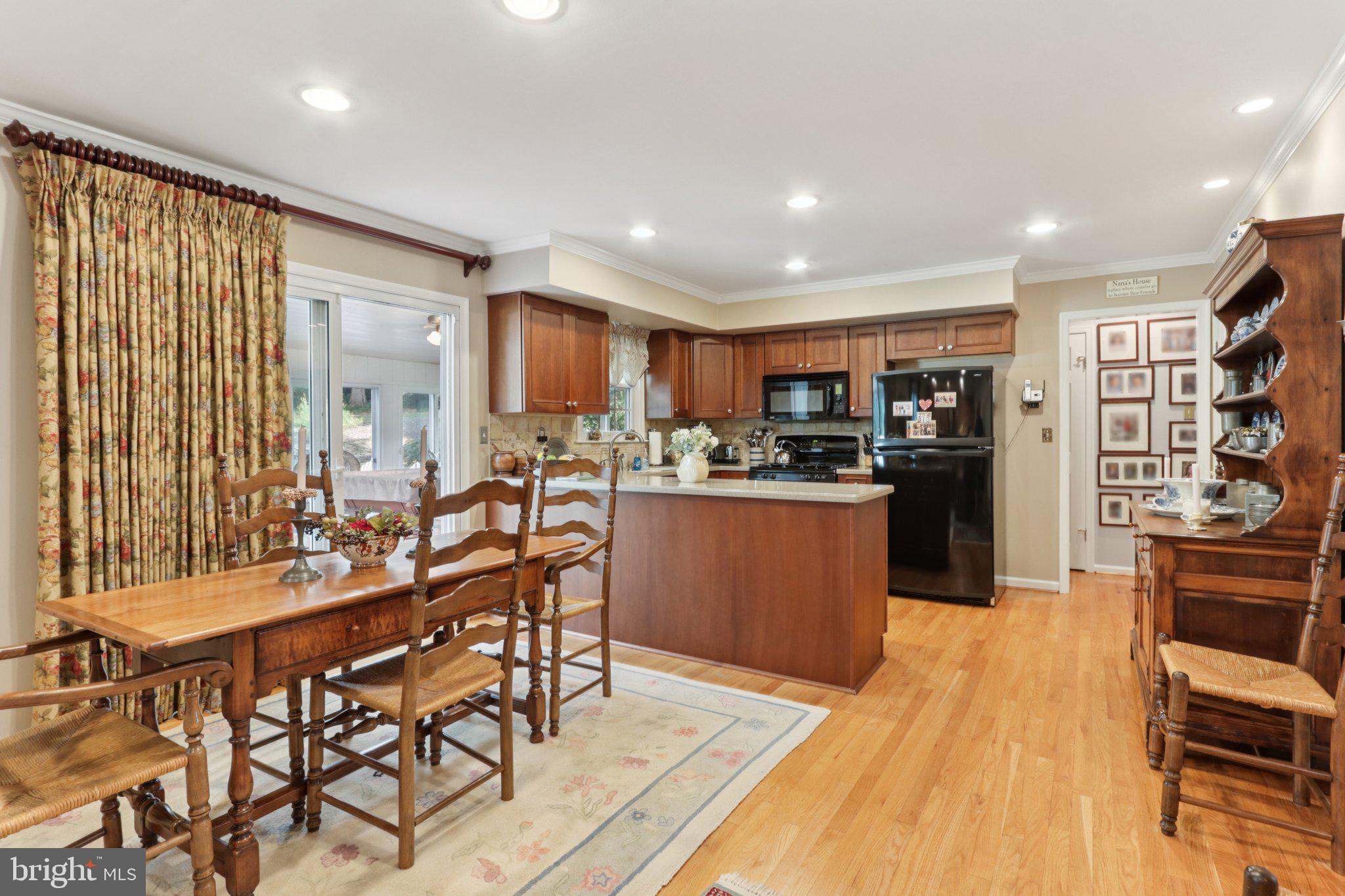 294 Batleson Road Ambler, PA 19002 - Photo 10 of 50 a kitchen with stainless steel appliances kitchen island granite countertop a table chairs and a refrigerator