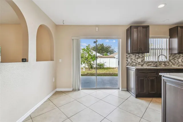 a kitchen with kitchen island a counter top space cabinets and stainless steel appliances