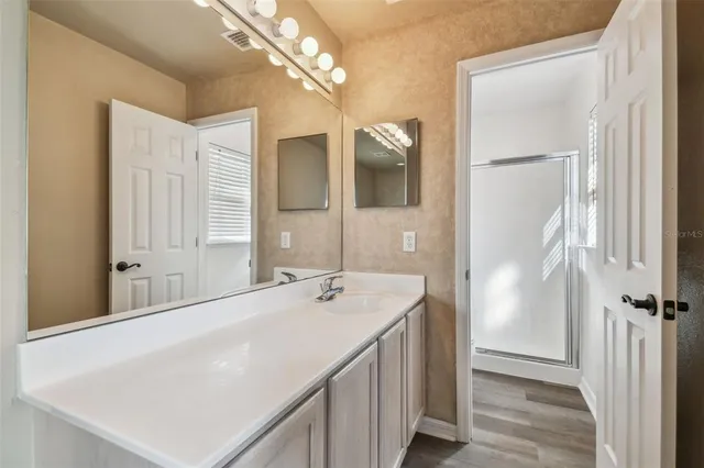 a bathroom with a bathtub a sink and a mirror