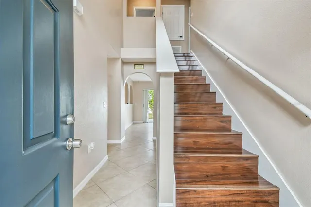 a view of entryway and hall with wooden floor