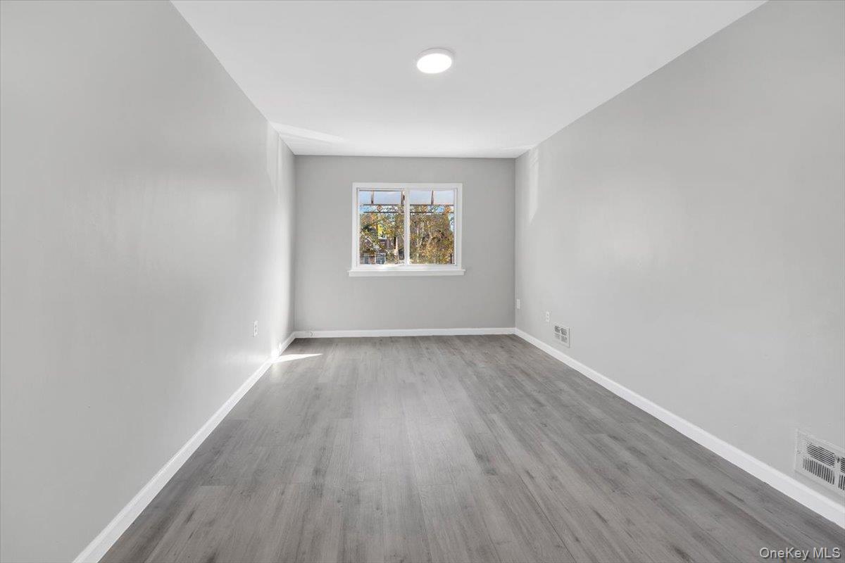 437 Torry Avenue, Unit 2 Bronx, NY 10473 - Photo 4 of 16 Empty room featuring light wood-type flooring and baseboards