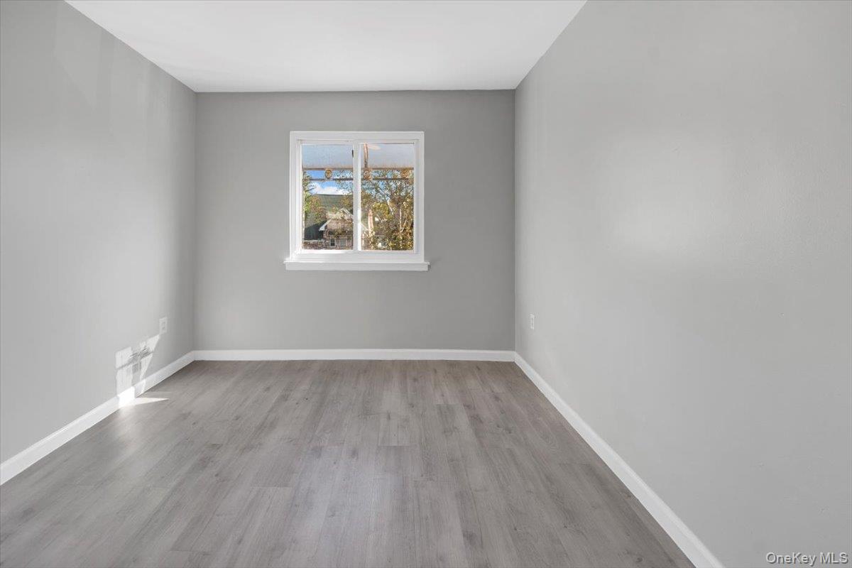 437 Torry Avenue, Unit 2 Bronx, NY 10473 - Photo 5 of 16 Spare room featuring baseboards and light wood-type flooring