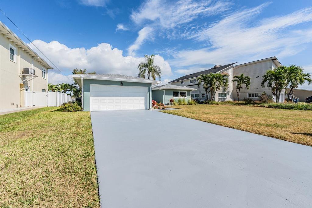 11305 5th Street East Treasure Island, FL 33706 - Photo 35 of 40 a view of a big yard next to a building