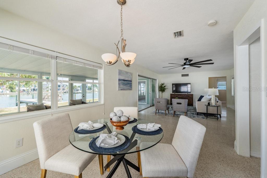 11305 5th Street East Treasure Island, FL 33706 - Photo 6 of 40 a dining room with furniture a chandelier and wooden floor