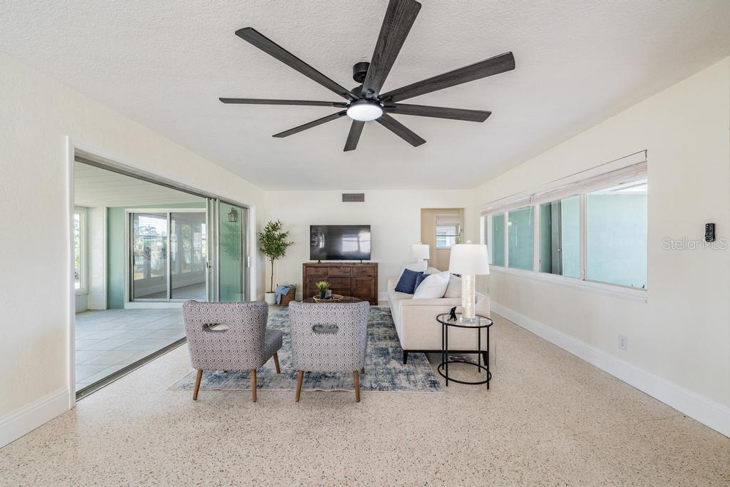 11305 5th Street East Treasure Island, FL 33706 - Photo 7 of 40 a living room with furniture a window and a ceiling fan
