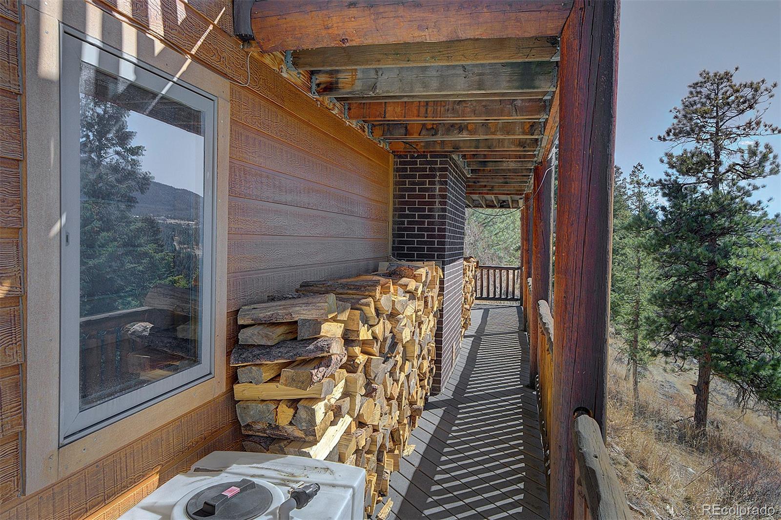 6561 Ridgeview Drive Morrison, CO 80465 - Photo 27 of 36 a view of balcony with wooden floor and iron fence
