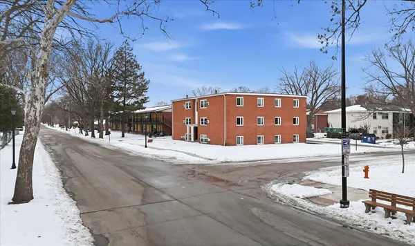 a view of a building with snow on the road