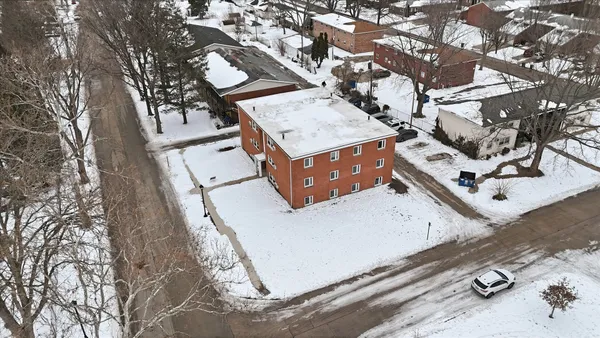 an aerial view of a house with swimming pool and sitting space