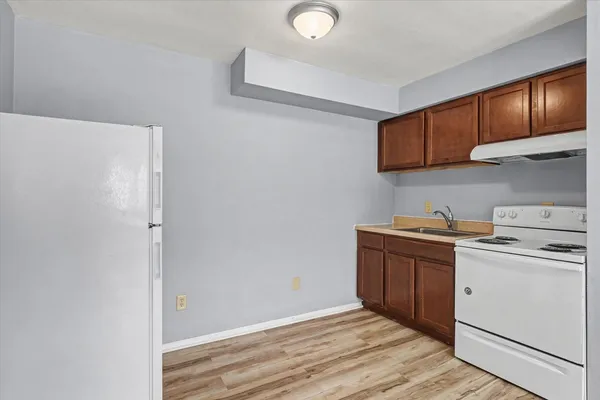 a view of a kitchen with sink and cabinets