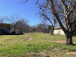 906 Virginia Street Graham, TX 76450 - Photo 4 of 4 a view of a yard with a tree