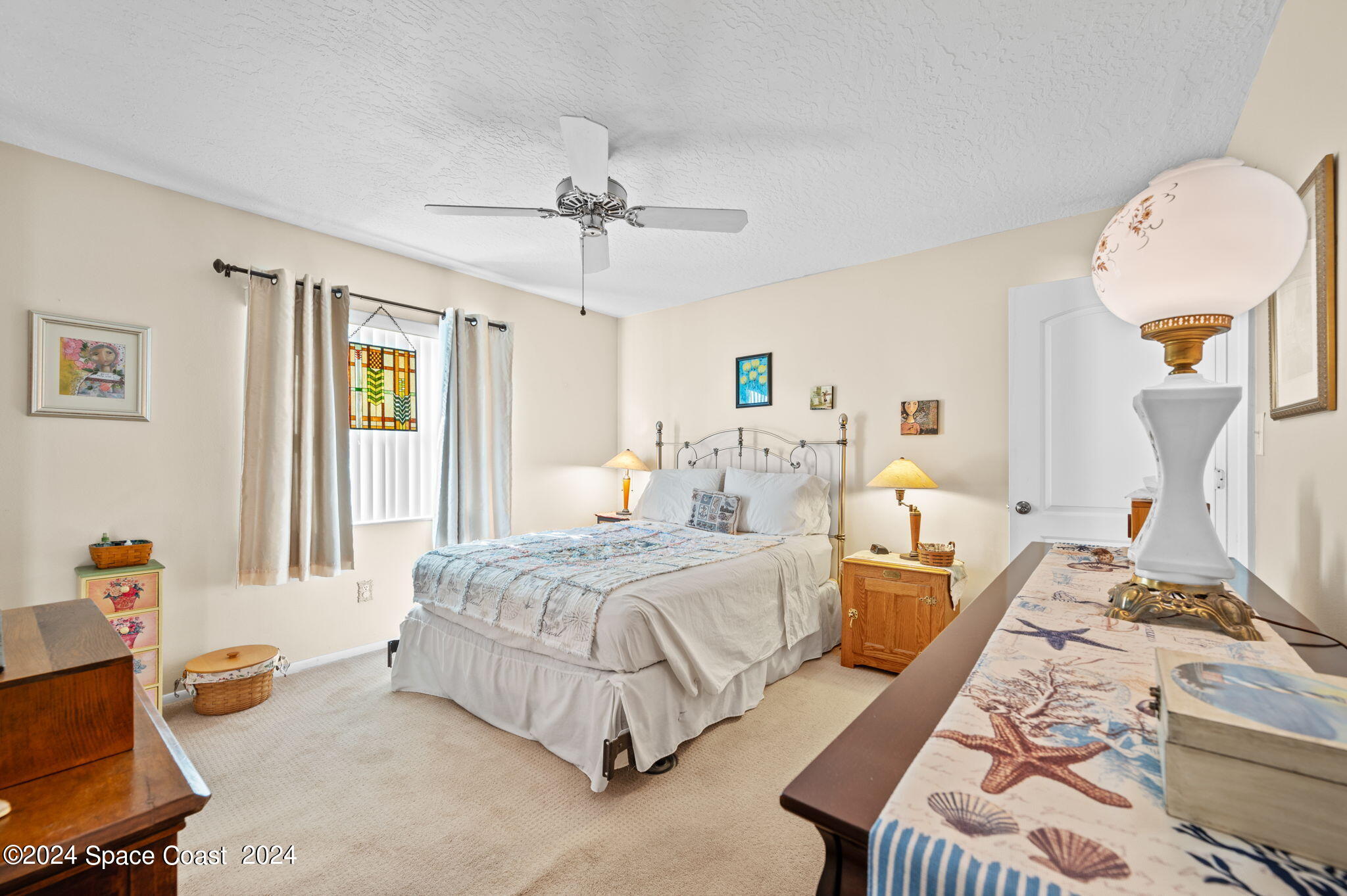 897 Brunswick Lane Rockledge, FL 32955 - Photo 14 of 41 a spacious bedroom with two beds and a chandelier