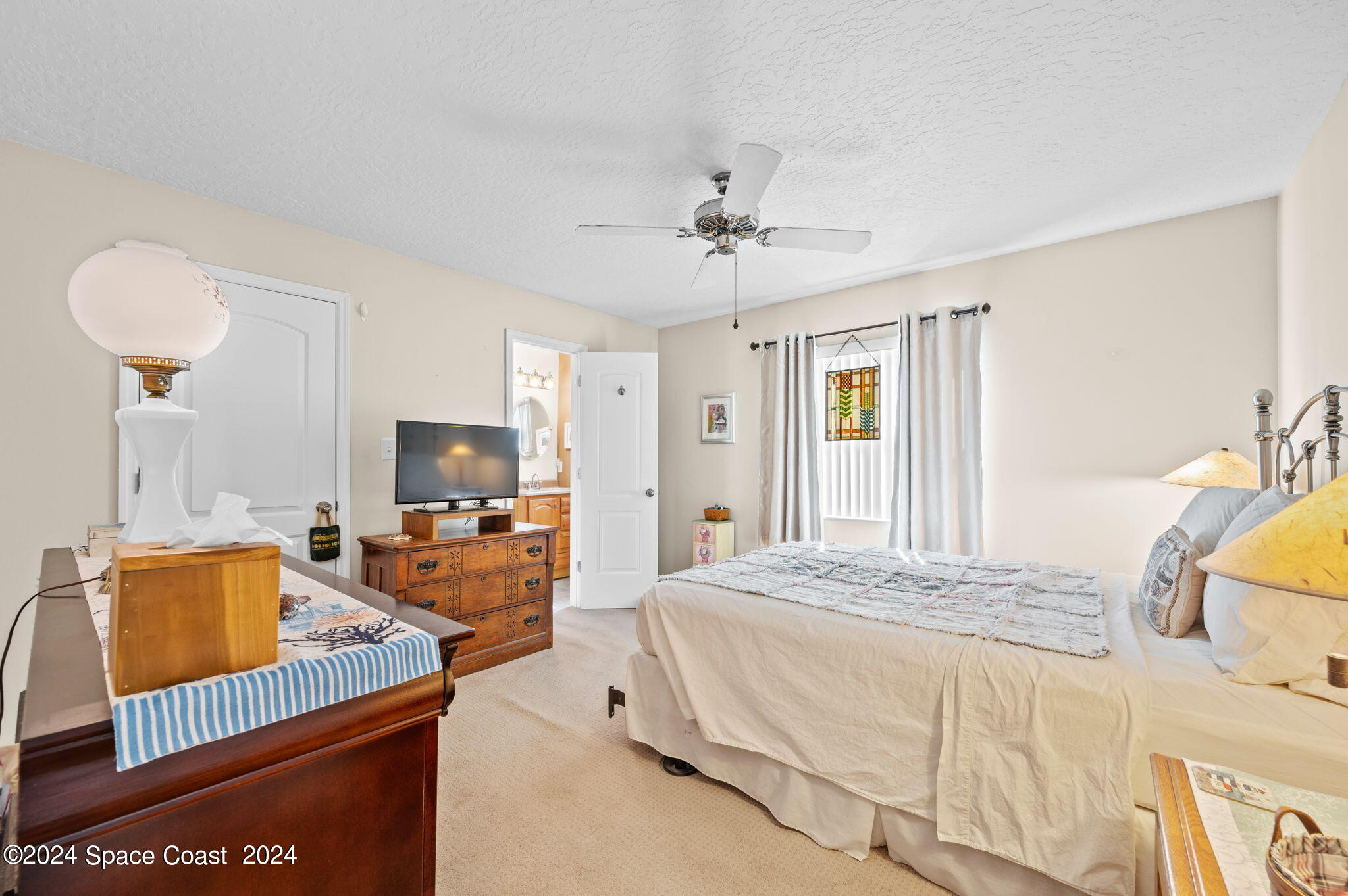897 Brunswick Lane Rockledge, FL 32955 - Photo 15 of 41 a bedroom with a bed and a flat screen tv