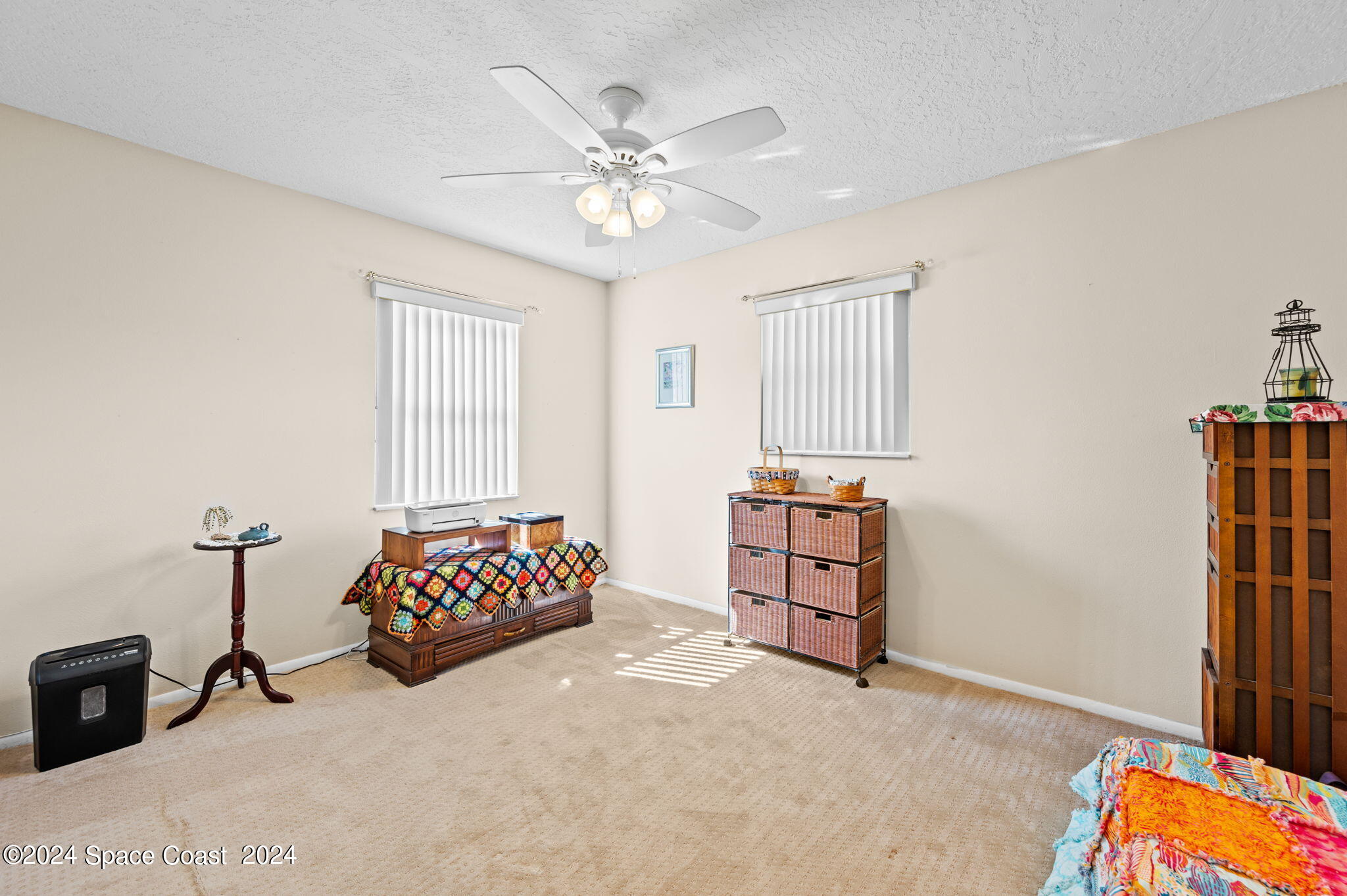 897 Brunswick Lane Rockledge, FL 32955 - Photo 19 of 41 a bedroom with a bed and a chandelier