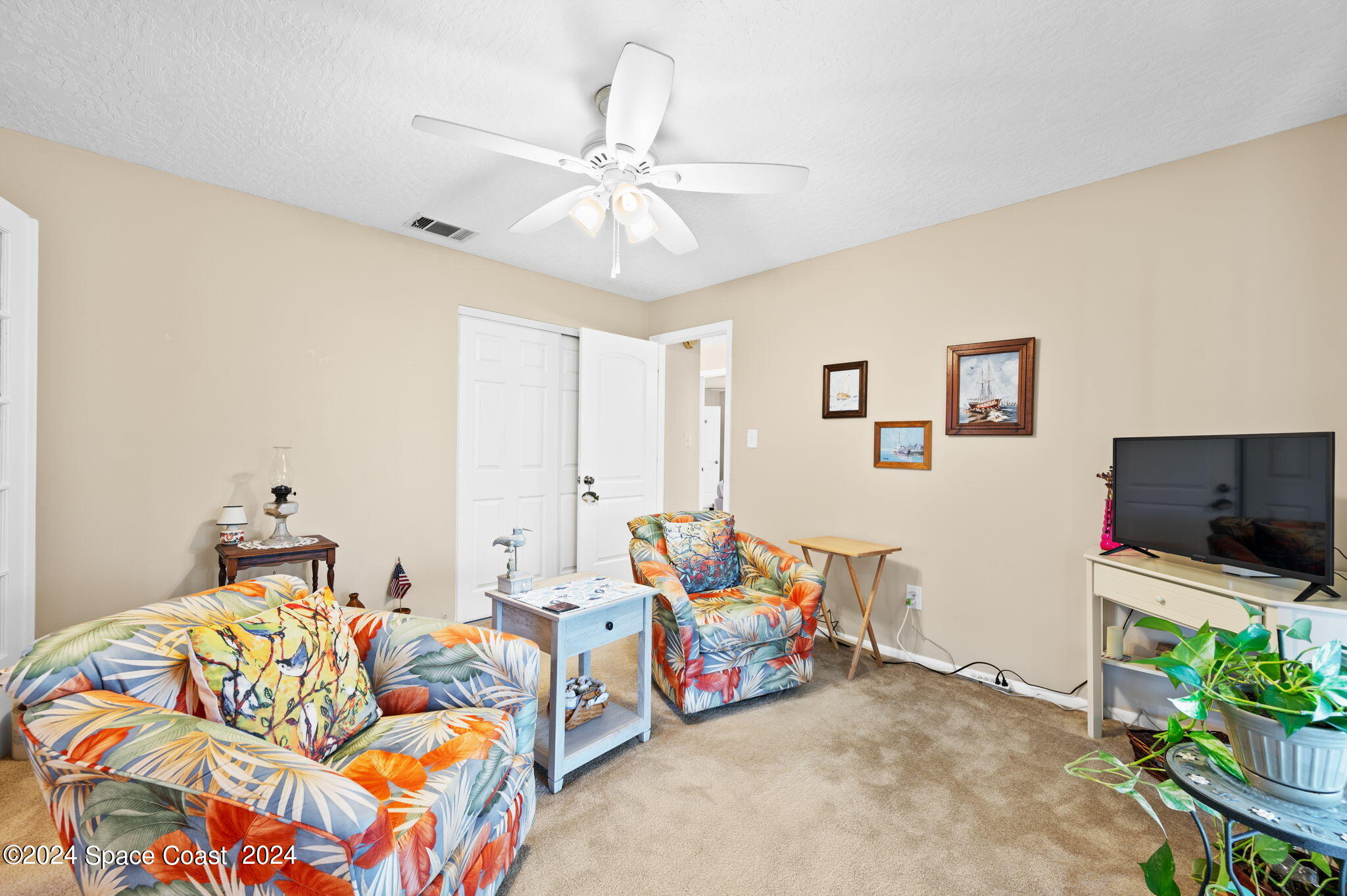 897 Brunswick Lane Rockledge, FL 32955 - Photo 23 of 41 a bedroom with furniture and a flat screen tv