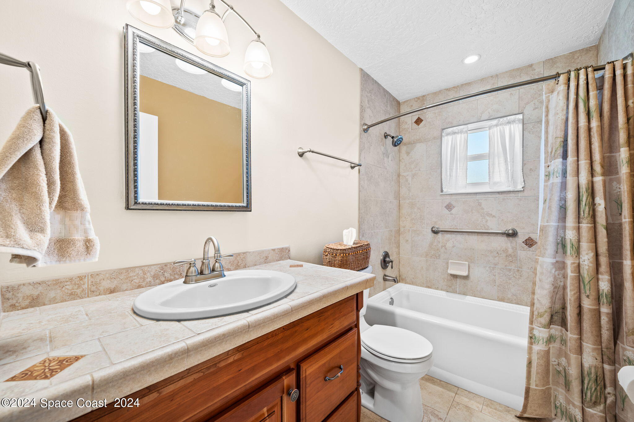 897 Brunswick Lane Rockledge, FL 32955 - Photo 24 of 41 a bathroom with a granite countertop sink toilet and shower