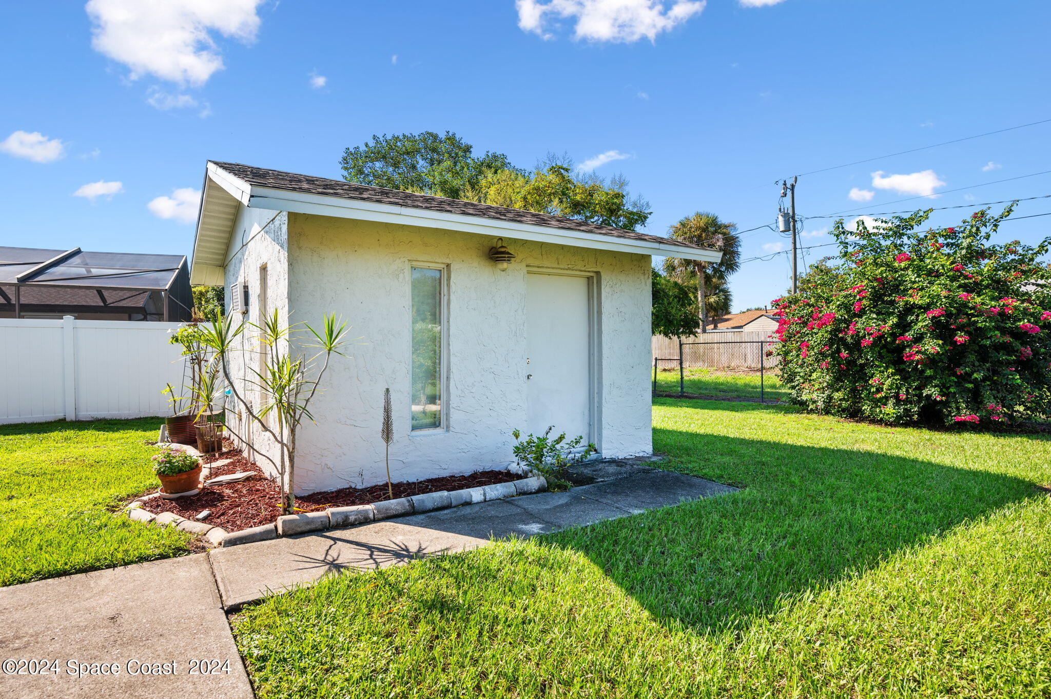 897 Brunswick Lane Rockledge, FL 32955 - Photo 28 of 41 a front view of a house with garden