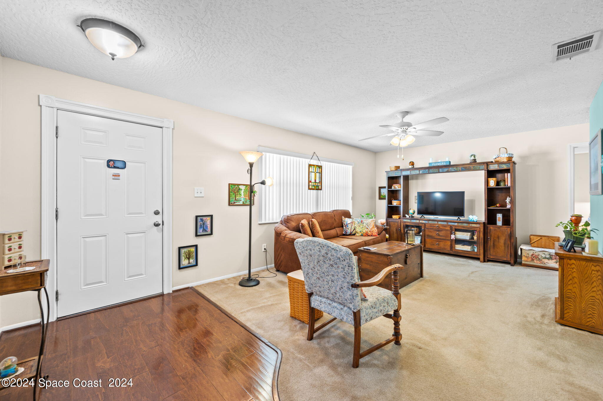 897 Brunswick Lane Rockledge, FL 32955 - Photo 4 of 41 a living room with furniture and a flat screen tv
