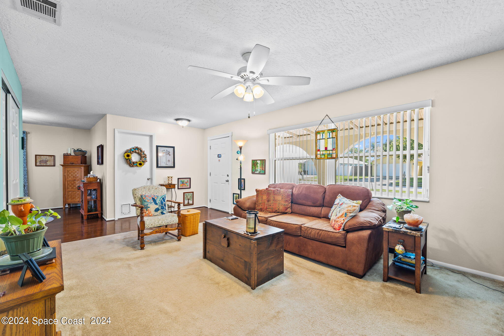 897 Brunswick Lane Rockledge, FL 32955 - Photo 6 of 41 a living room with furniture a couch and a chandelier