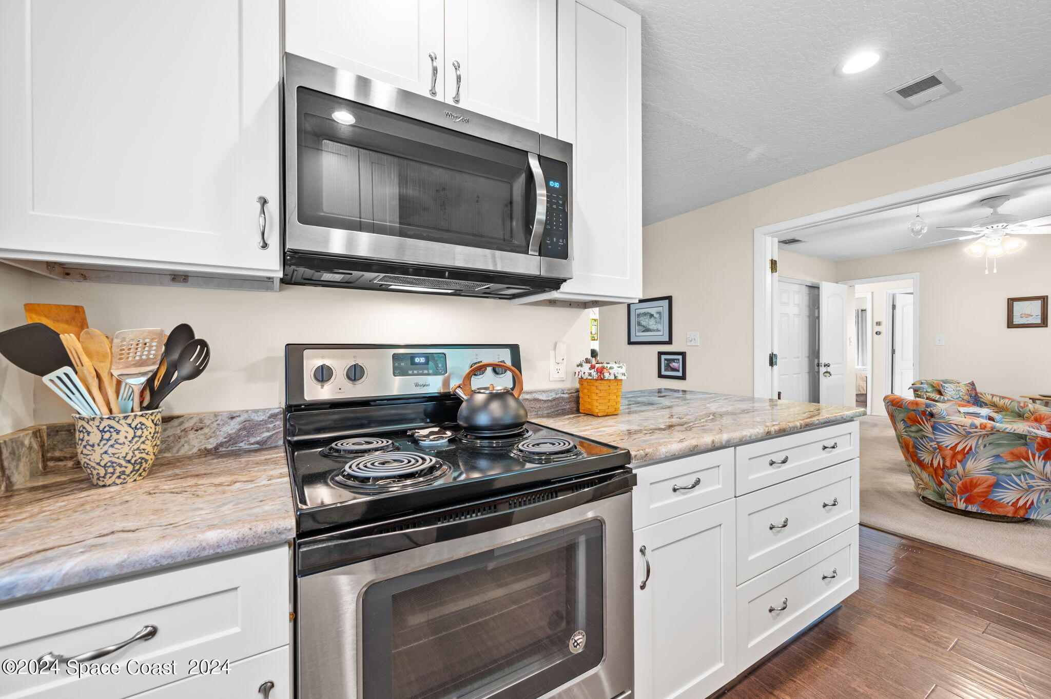 897 Brunswick Lane Rockledge, FL 32955 - Photo 7 of 41 a kitchen with stainless steel appliances granite countertop a stove and a microwave