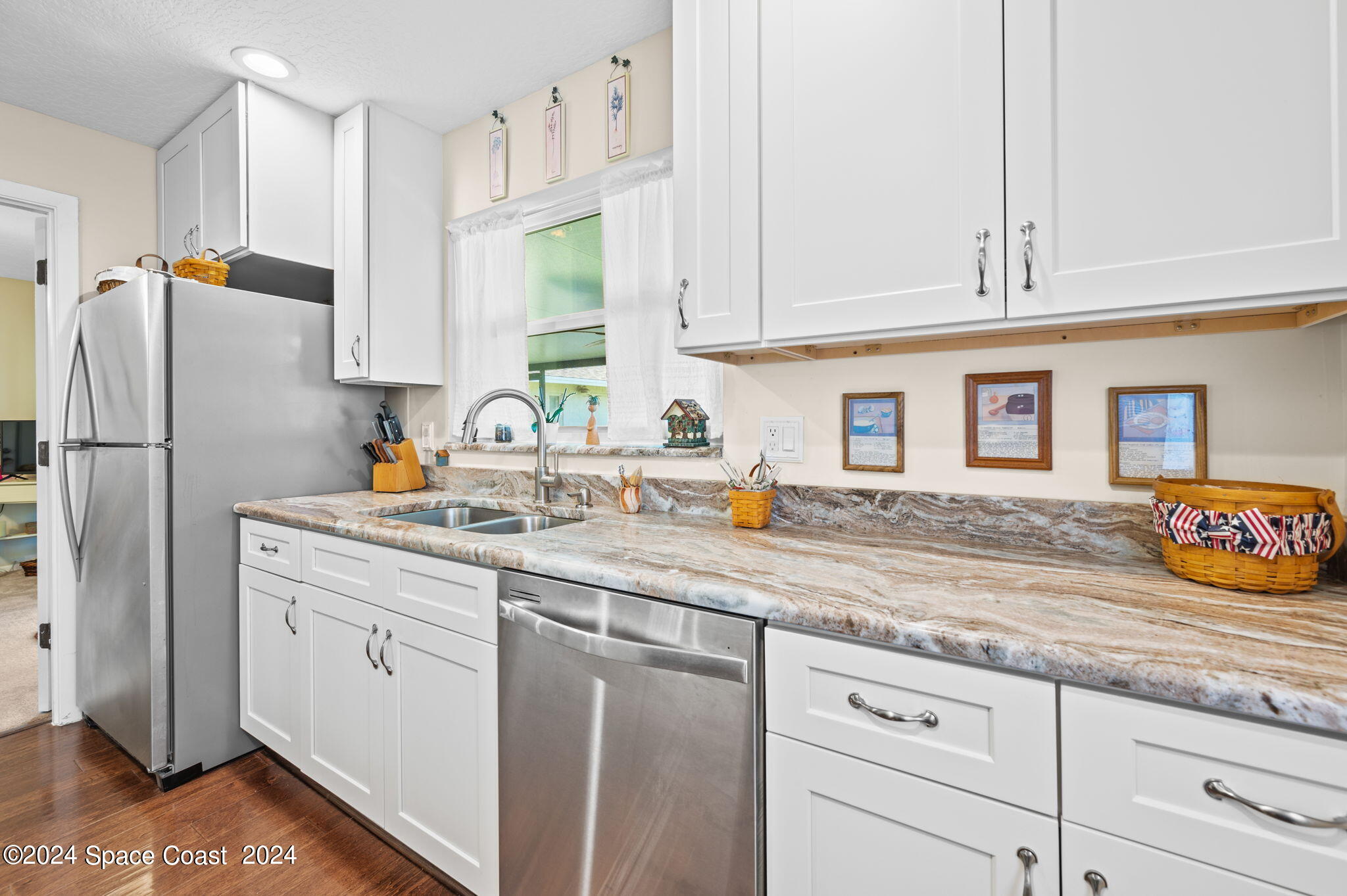 897 Brunswick Lane Rockledge, FL 32955 - Photo 8 of 41 a kitchen with stainless steel appliances granite countertop a sink and a refrigerator