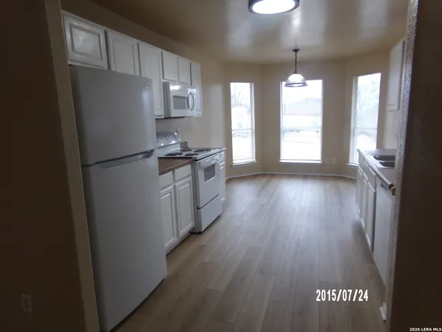 a kitchen with granite countertop stainless steel appliances a refrigerator a sink and a stove