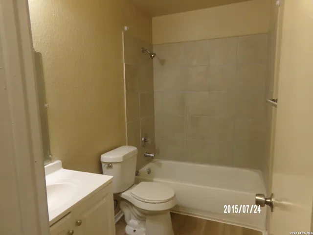 a bathroom with a shower a toilet and a sink