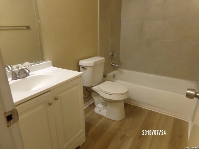 a white toilet sitting next to a bathroom sink