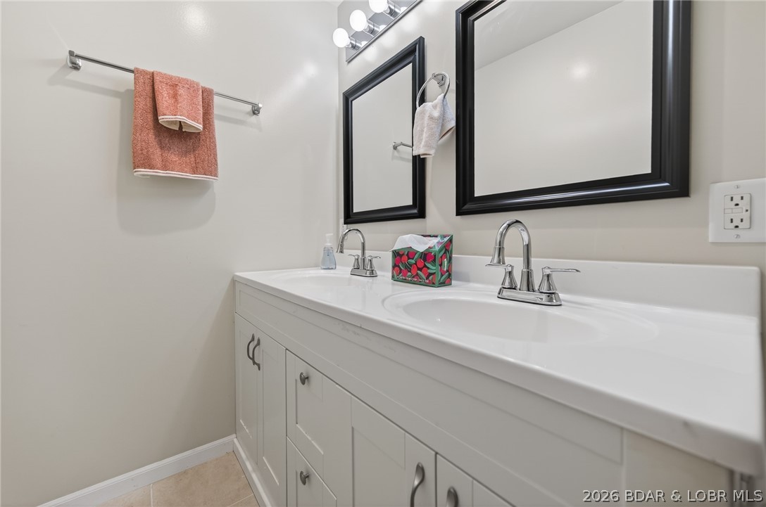 177 Storage Road Eldon, MO 65026 - Photo 19 of 34 The primary bath's double vanity also serves to pr