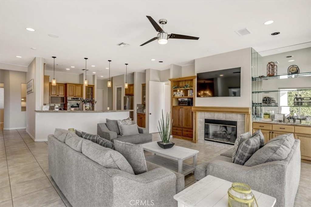 a living room with furniture kitchen view and a fireplace