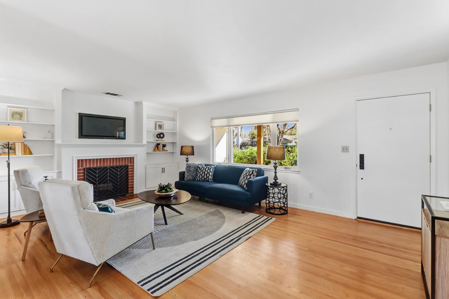709 A Street Davis, CA 95616 - Photo 11 of 74 a living room with furniture a fireplace and a flat screen tv