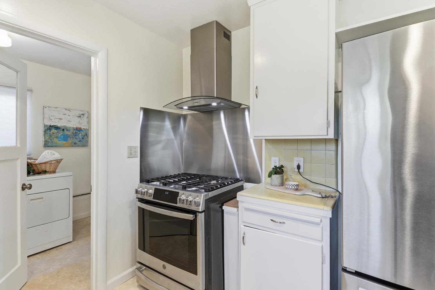 709 A Street Davis, CA 95616 - Photo 22 of 74 a kitchen with white cabinets and appliances