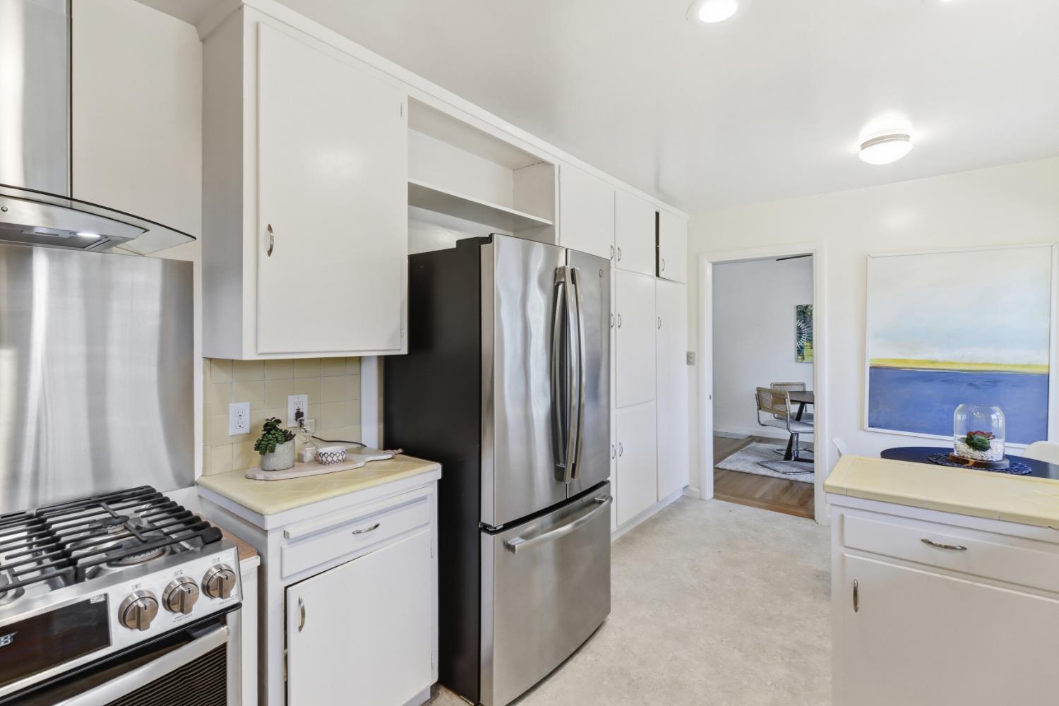 709 A Street Davis, CA 95616 - Photo 23 of 74 a kitchen with a refrigerator and a stove top oven
