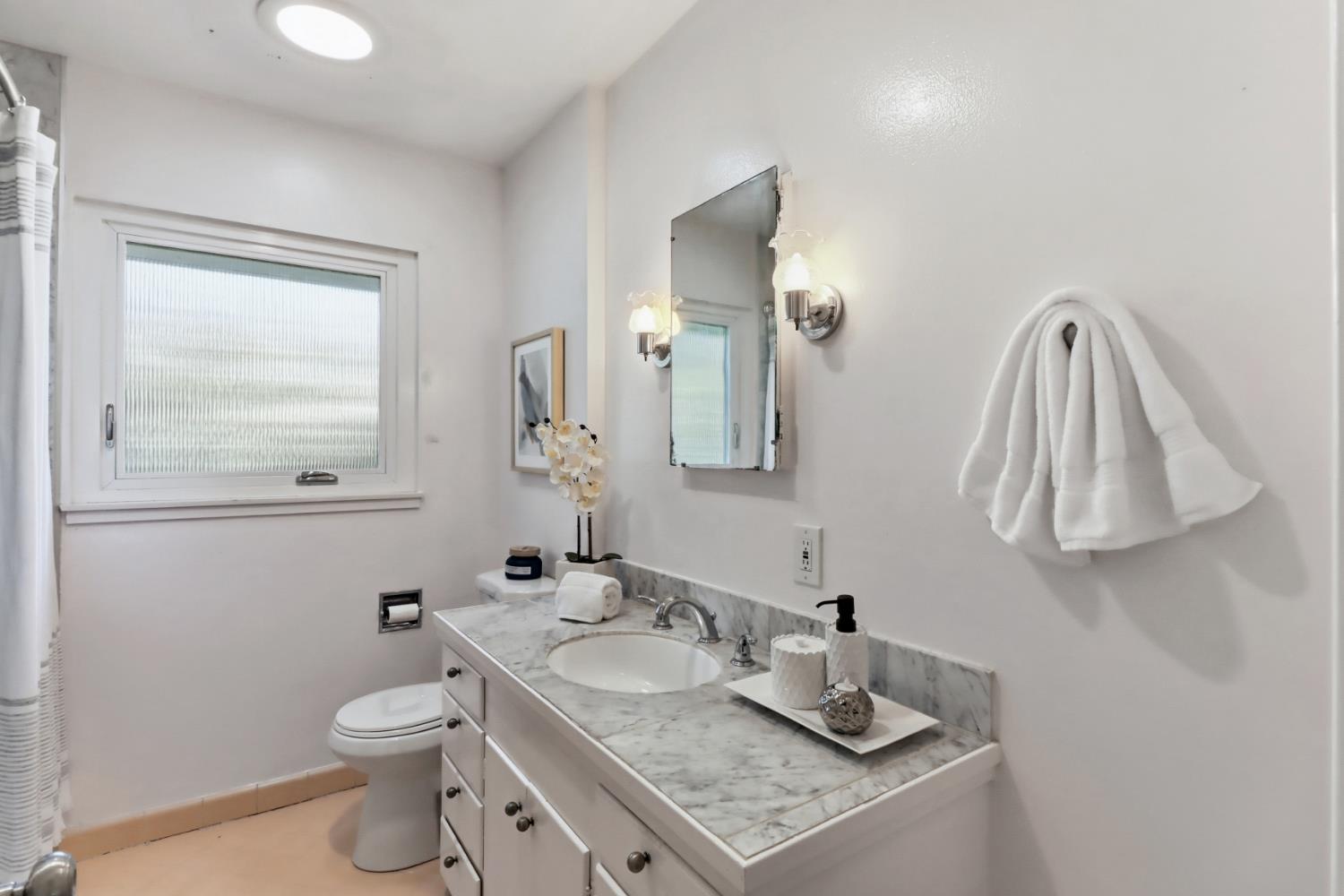 709 A Street Davis, CA 95616 - Photo 31 of 74 a bathroom with a toilet sink and mirror