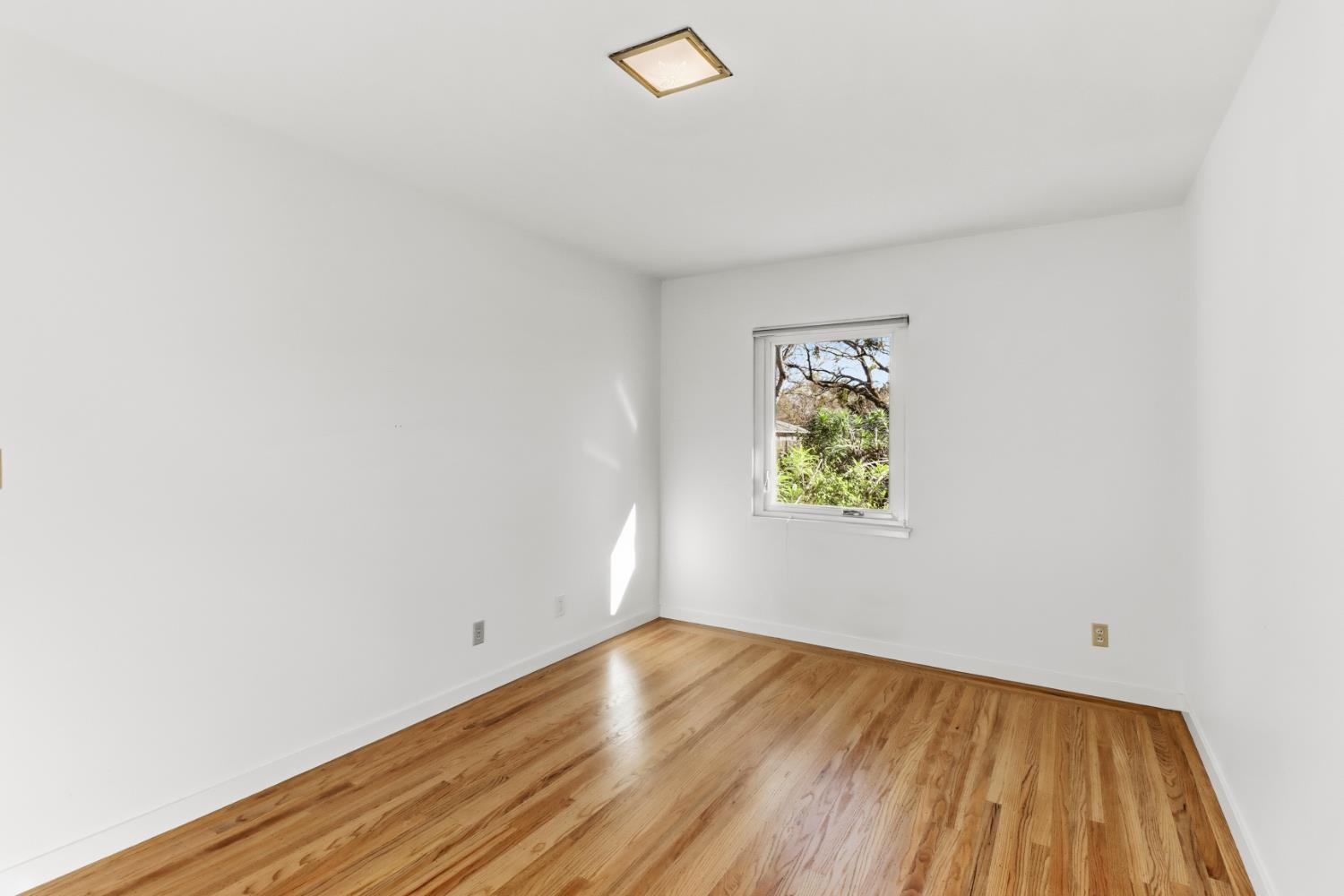 709 A Street Davis, CA 95616 - Photo 37 of 74 a view of room with window and wooden floor